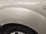 a close up of a white truck with a black stripe on it