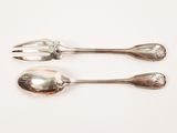 two silver spoons and a fork on a white surface