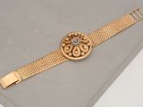 an image of a close up of a watch on a table