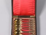 silverware in a wooden case with red velvet lining