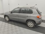 the back end of a silver volkswagen suv parked in a garage