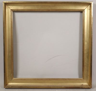 a close up of a gold picture frame on a white wall