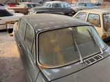 many old cars parked in a parking lot