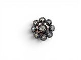 a black and white diamond flower broochle on a white background