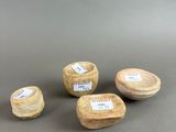 three small wooden bowls with labels on them sitting on a table