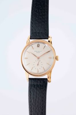 a close up of a watch on a black leather strap