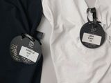 a white shirt and a black shirt with a name tag on it