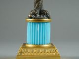 a statue of an eagle on a pedestal with a blue base