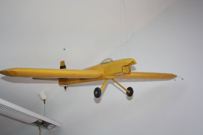 a toy airplane hanging on the wall in a room