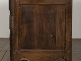 an old wooden cabinet with a marble top on a parquet floor