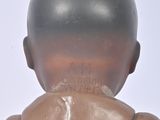 a close up view of a baby doll with a bald head