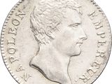 a close up of a coin with a man ' s head on it