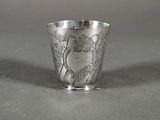 a silver cup with a design on it on a table