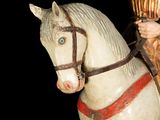 a statue of a man riding a horse on a black background