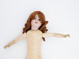 a doll that is laying down on a white surface
