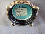 a picture of a blue and gold plate with a label on it