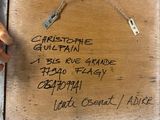 a person holding a wooden box with writing on it