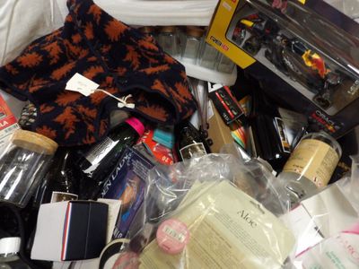 a pile of bottles of wine and other items on a bed