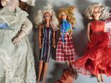 five dolls that are lined up together on a table