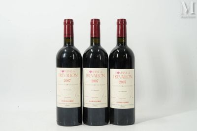 trois bouteilles de vin rouge posées côte à côte sur une table