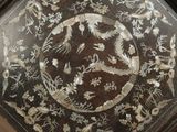 a picture of a decorative table with flowers and birds on it