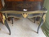 a black table with a gold decoration on top of it