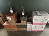 several boxes of wine are stacked on top of each other in a room