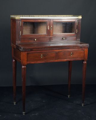 un bureau ancien en acajou, orné de garnitures en laiton et doté de tiroirs