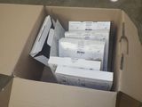 a cardboard box full of files and papers sitting on the floor