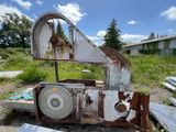 a rusted out machine sitting in the middle of a field