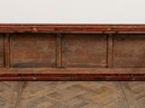 an old wooden bench sitting on top of a hard wood floor