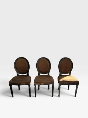a set of four chairs with brown upholstered upholstered seats