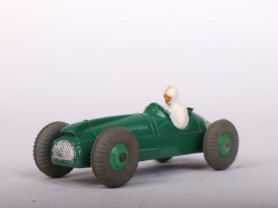 a green toy car with a white dog in it