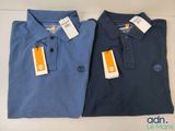 two men ' s polo shirts with tags on them sitting next to each other
