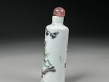 a white and pink glass snuff bottle with a dragon on it