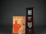 two framed medals and a plaque with a picture of a man
