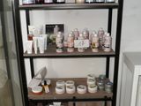 a shelf that has many different types of skin care products on it