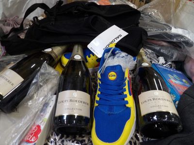 many bottles of wine and a pair of shoes on a table