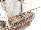 a model of a ship on display on a white surface