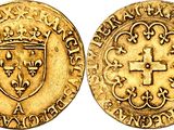 a gold coin with a cross and shield on it