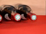 several bottles of wine are lined up on a red table