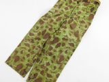 a close up of a camouflage pants on a white surface