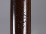 a wooden baseball bat with a engraved inscription on it