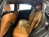 the back seats of a car are tan leather with black trims