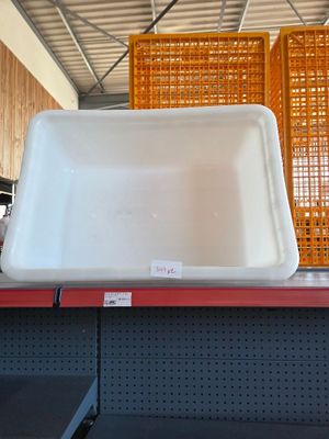a white sink sitting on top of a shelf in a store
