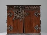 an old wooden cabinet with ornate carvings on the doors