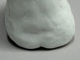 a white vase that has a cat face on it