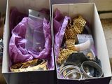two boxes with different items in them on the floor