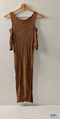 an image of a brown dress hanging on a hanger on a wall