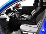 the interior of a blue car with black seats and a steering wheel